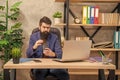 busy confident bearded boss study online on laptop hold coffee in the office, modern life