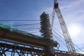 Busy construction site with multiple large cranes working in tandem to construct a building Royalty Free Stock Photo