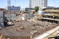 Busy construction site, with workers and heavy machinery