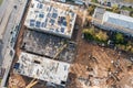 Busy construction site with working cranes and machines for earthwork. aerial top view