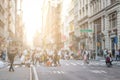 Busy crowds of people walk across the intersection in SoHo New York City