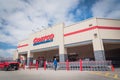 Busy customers walking in and exit the Costco Wholesale store in Lewisville, Texas in cloud blue sky
