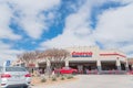 Busy customers walking in and exit the Costco Wholesale store in Lewisville, Texas in cloud blue sky