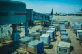 Busy day at the airport. Preparation of the airplane before flight. Cargo containers waiting load into an airliner Royalty Free Stock Photo