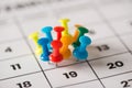 Busy day concept. Cropped close up view photo image of lot of thumbtacks attached to the calendar Royalty Free Stock Photo