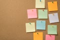 Busy day at work concept. Photo of lot of colorful notepaper attached with pins to the wooden board Royalty Free Stock Photo