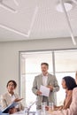 Busy diverse executive team with leader discussing work at meeting. Vertical Royalty Free Stock Photo