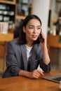 Busy Asian young business woman manager talking on phone making call. Royalty Free Stock Photo