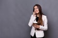 Smiling business woman speaking mobile phone and drinking coffee at work Royalty Free Stock Photo