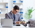 Busy employee chained to his office desk Royalty Free Stock Photo