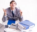 Busy employee chained to his office desk Royalty Free Stock Photo