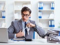 Busy employee chained to his office desk Royalty Free Stock Photo