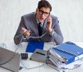 Busy employee chained to his office desk Royalty Free Stock Photo