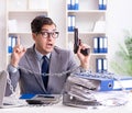 Busy employee chained to his office desk Royalty Free Stock Photo