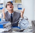 Busy employee chained to his office desk Royalty Free Stock Photo