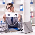 Busy employee chained to his office desk Royalty Free Stock Photo