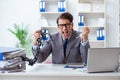 The busy employee chained to his office desk Royalty Free Stock Photo