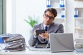 The busy employee chained to his office desk Royalty Free Stock Photo