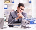 Busy employee chained to his office desk Royalty Free Stock Photo