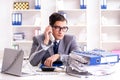 Busy employee chained to his office desk Royalty Free Stock Photo