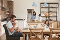 Busy Family Home With Father Working As Mother Prepares Meal Royalty Free Stock Photo