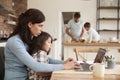 Busy Family Home With Mother Working As Father Prepares Meal Royalty Free Stock Photo