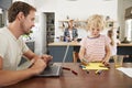 Busy family kitchen, dad and son working at table, close up Royalty Free Stock Photo