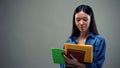 Busy female holding notebooks and writing schedule, time management concept Royalty Free Stock Photo