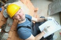 Busy foreman worker make plan for further construction works on object