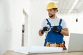 Busy handyman, electrician using insulating tape while installing new electrical socket outlet in apartment Royalty Free Stock Photo