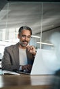 Busy happy mature business man executive sitting at desk using laptop. Vertical. Royalty Free Stock Photo