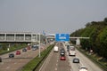 Busy highway at peak hour in Frankfurt, Germany. Plane on bridge over motorway