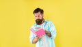 busy hipster guy reading notebook on yellow background, erudition