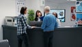 Busy hospital reception desk with many patients waiting Royalty Free Stock Photo