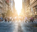 Busy intersection with crowds of people at 23rd Street and 5th Avenue in New York City with sunlight glowing Royalty Free Stock Photo