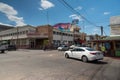 Busy intersection in Mexican town with post office and hotel.