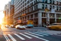 Busy intersection on 5th Avenue and 23rd Street in New York City with rush hour traffic