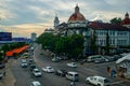 Busy intersection in Yangon with traffic and colonial buildings at dusk