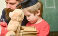 Busy kid studying at school. Individual studying concept. Teacher, father checking homework, helps to boy, son. Teacher Royalty Free Stock Photo