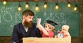 Busy kid studying at school. Teacher, father checking homework, helps to boy, son. Individual studying concept. Teacher Royalty Free Stock Photo