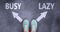 Busy and lazy as different choices in life - pictured as words Busy, lazy on a road to symbolize making decision and picking