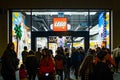 A busy Lego toys shop is seen at night with a crowd outside and a waiting line as the Christmas shopping season begins in