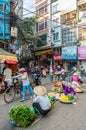 Busy local daily life of the morning street market in Hanoi, Vietnam. A busy crowd of sellers and buyers in the market.