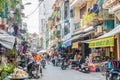 Busy local daily life of the morning street market in Hanoi, Vietnam. A busy crowd of sellers and buyers in the market.