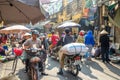 Busy local daily life of the morning street market in Hanoi, Vietnam. A busy crowd of sellers and buyers in the market.