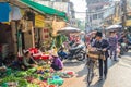 Busy local daily life of the morning street market in Hanoi, Vietnam. A busy crowd of sellers and buyers in the market.