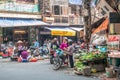 Busy local daily life of the morning street market in Hanoi, Vietnam. A busy crowd of sellers and buyers in the market.