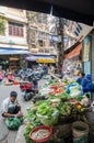 Busy local daily life of the morning street market in Hanoi, Vietnam. A busy crowd of sellers and buyers in the market. Royalty Free Stock Photo