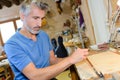 Busy luthier in workshop