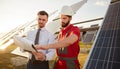 Contractor and manager working in field with solar panels Royalty Free Stock Photo